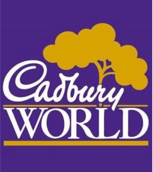 On a purple background, different fonts read Cadbury with World underneath. Above the text, there is a golden coco bean tree.